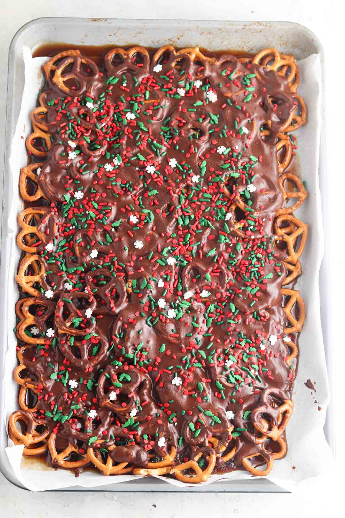 Chocolate covered pretzels with sprinkles on top.