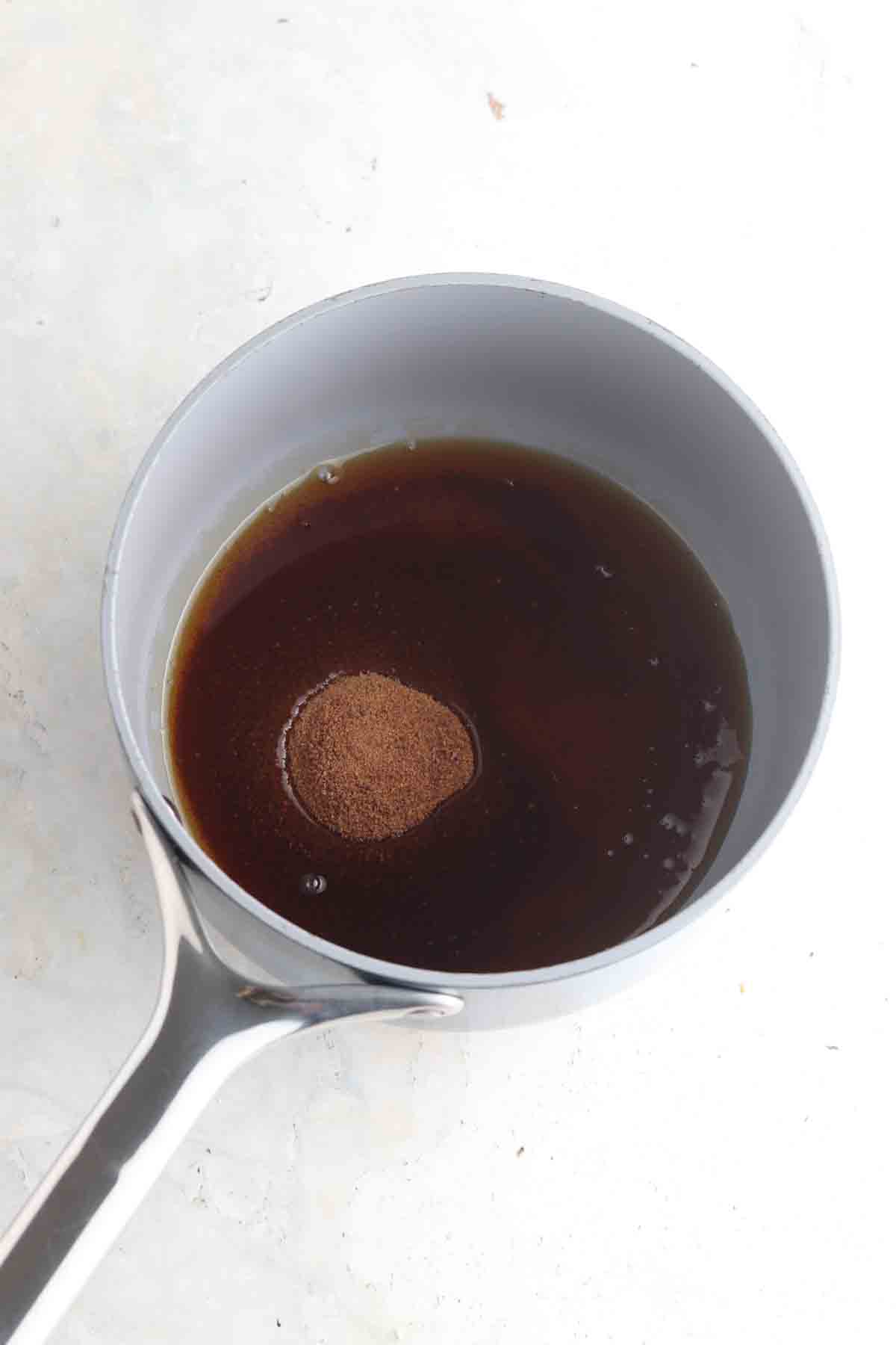 Coconut sugar, coconut oil and maple syrup in a sauce pot.