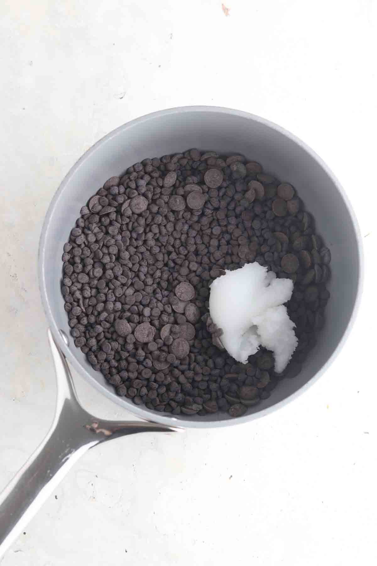 Chocolate and coconut oil in a sauce pan.
