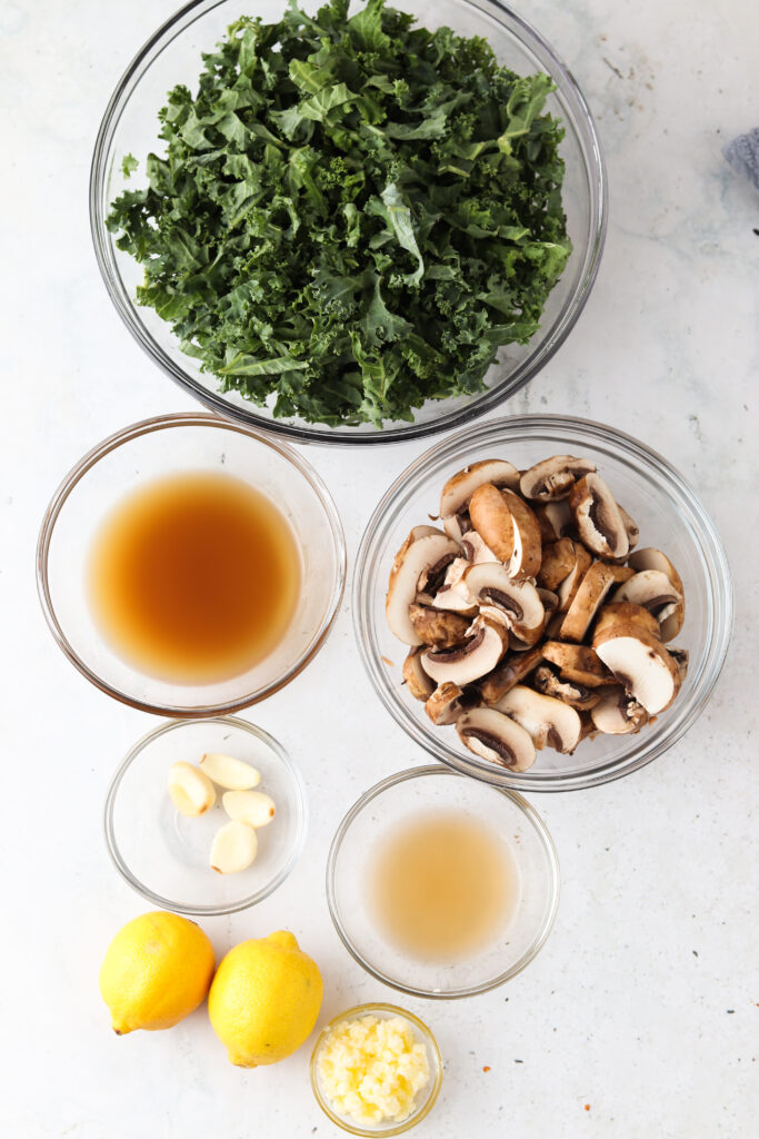 sauteed kale and mushroom ingredients laid out in bowls