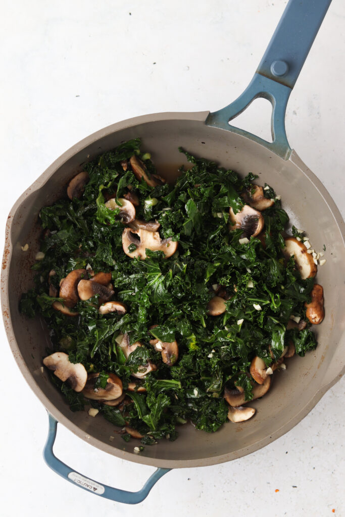 kale and mushrooms in a pan