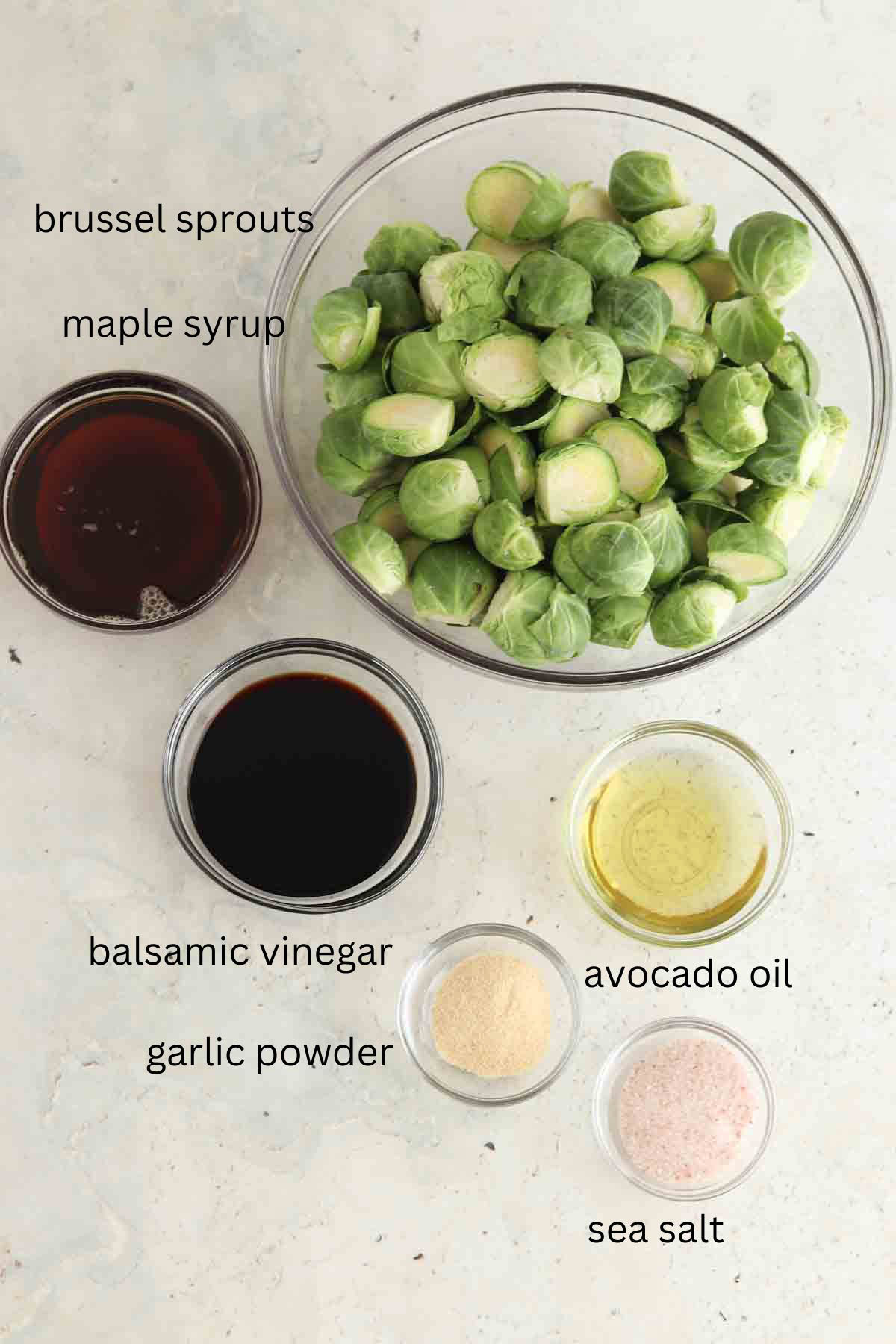 Balsamic maple brussel ingredients laid out in glass bowls. 