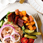 deconstructed burger bowls with sweet potatoes, pickles, tomatoes, and bacon