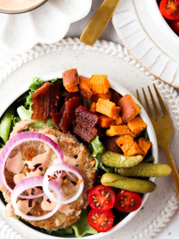 deconstructed burger bowls with sweet potatoes, pickles, tomatoes, and bacon