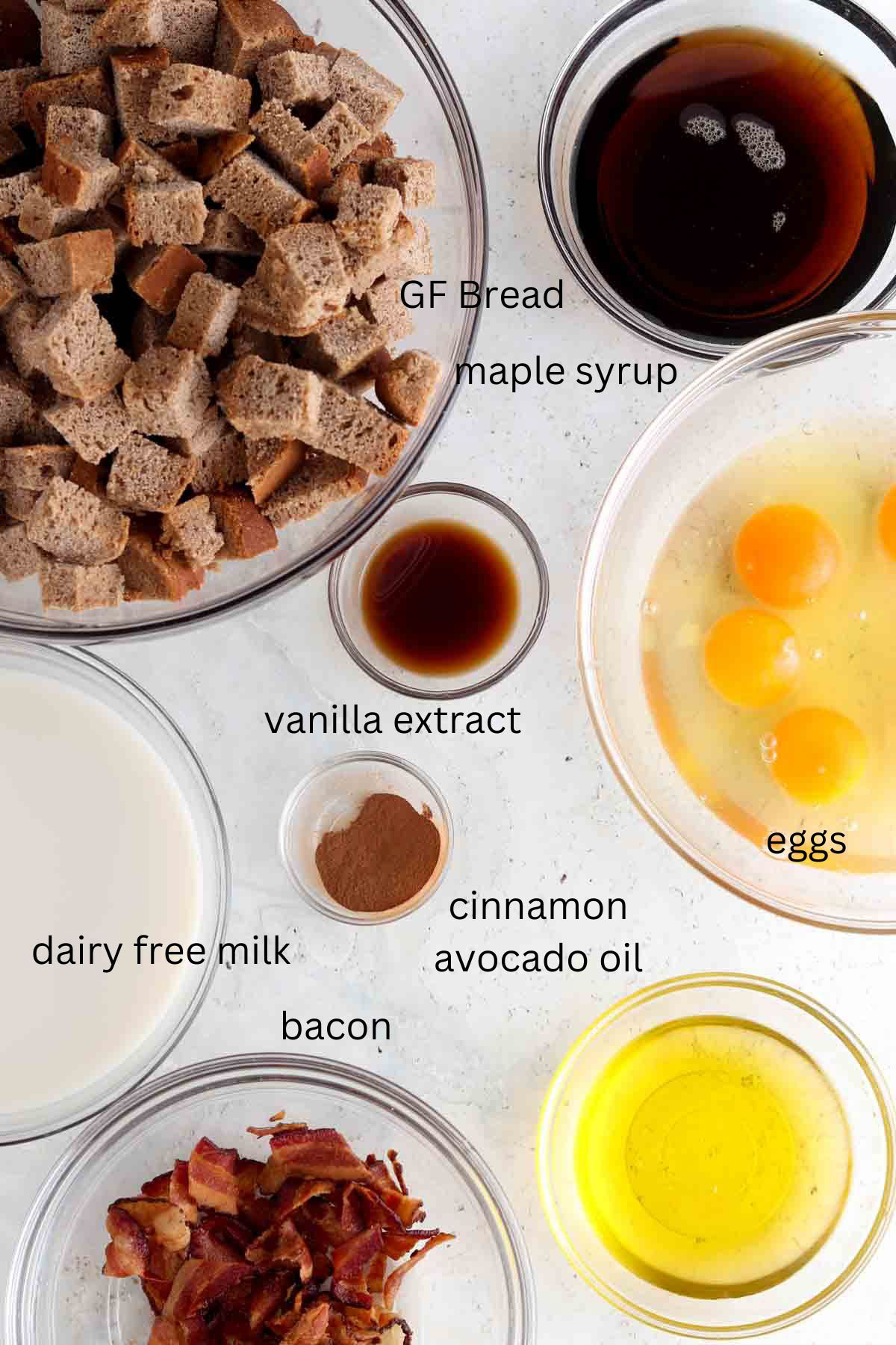 French toast ingredients laid out in small glass bowls on the counter. 