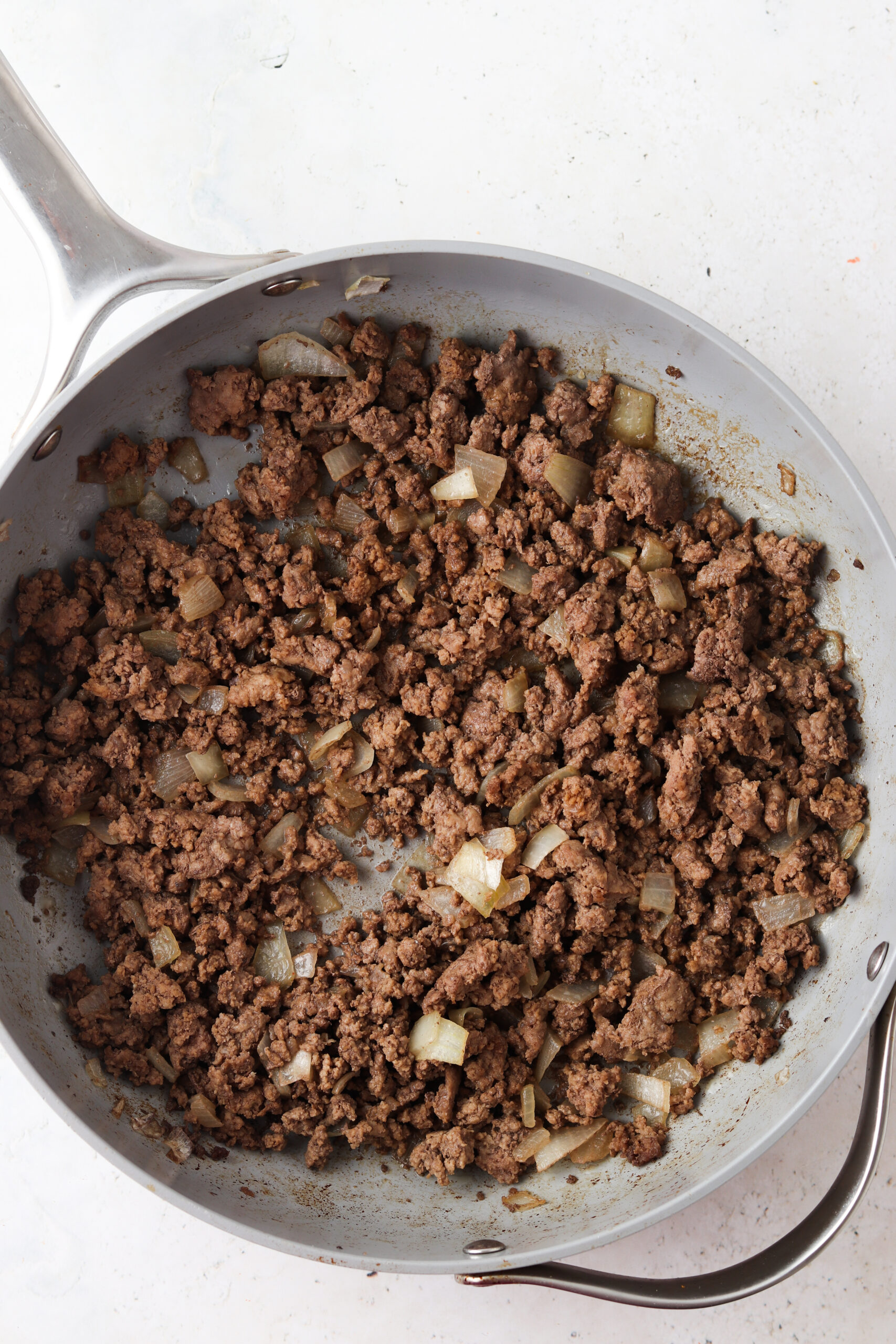 Ingredients for Big Mac casserole in a frying pan.