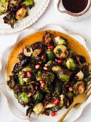 maple brussel sprouts on a plate with pomegranate