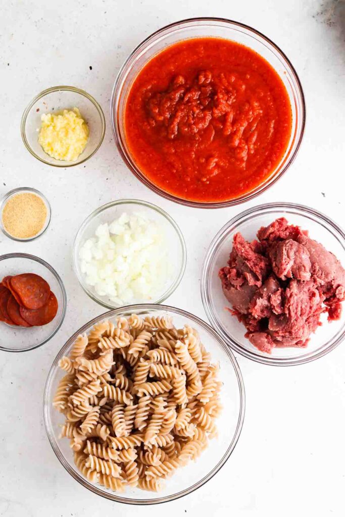 pizza casserole ingredients in bowls laid out