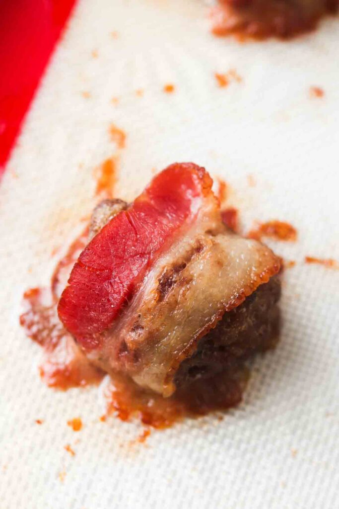 meatballs on a baking sheet wrapped in bacon