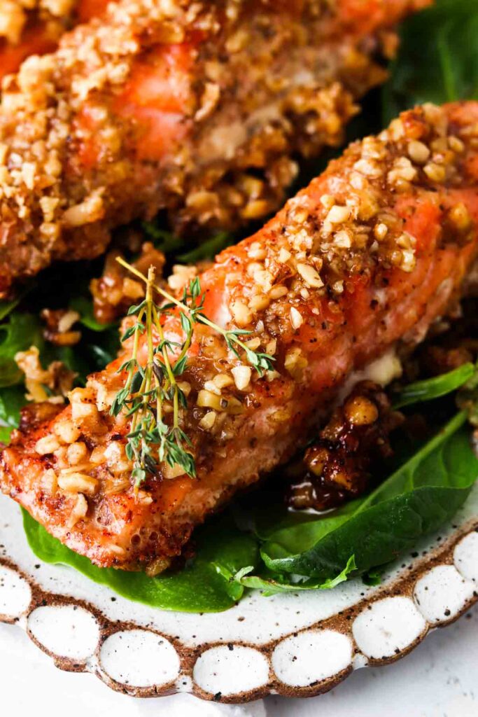 close up picture of maple crusted salmon with thyme on top