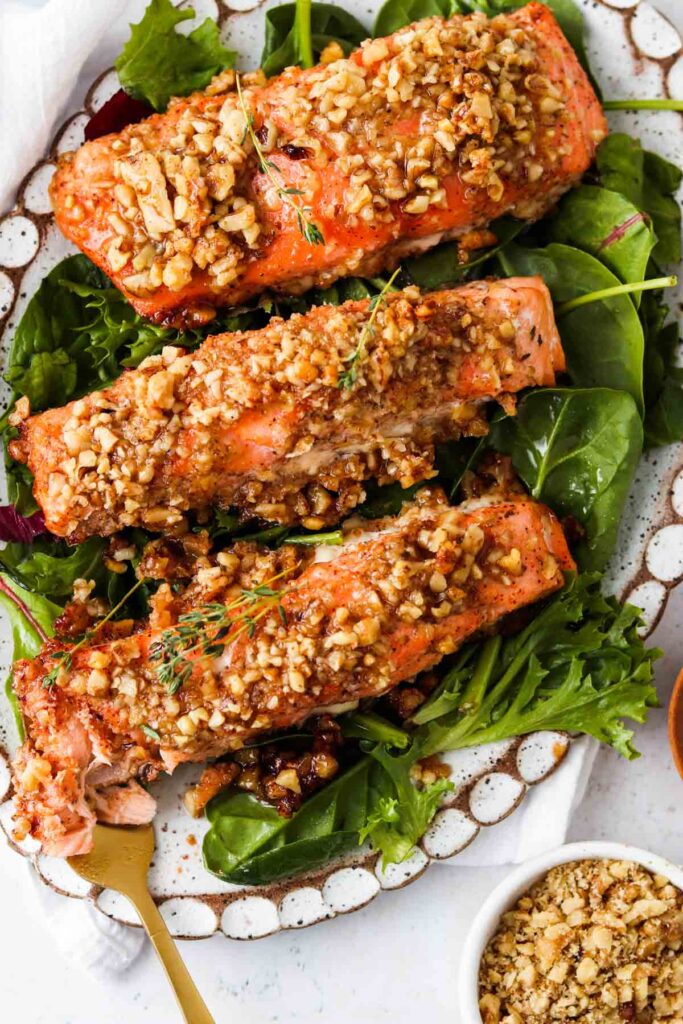 maple crusted salmon on a platter with greens