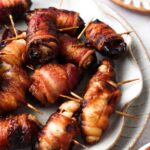 bacon wrapped dates on a place