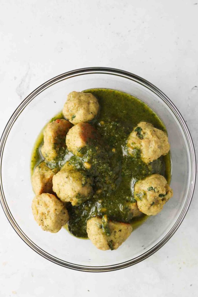 chicken meatballs tossed in pesto saice