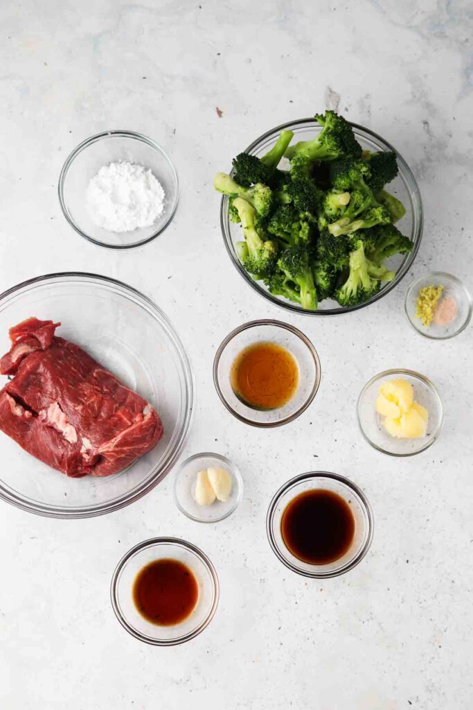 beef, broccoli, and other ingredients laid out in bowls