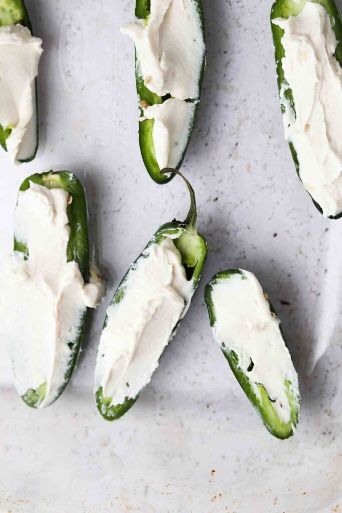 jalapenos on a baking dish with cream cheese