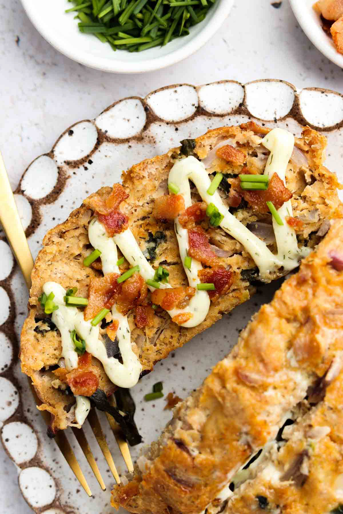 Keto turkey meatloaf on a platter with a gold knife.