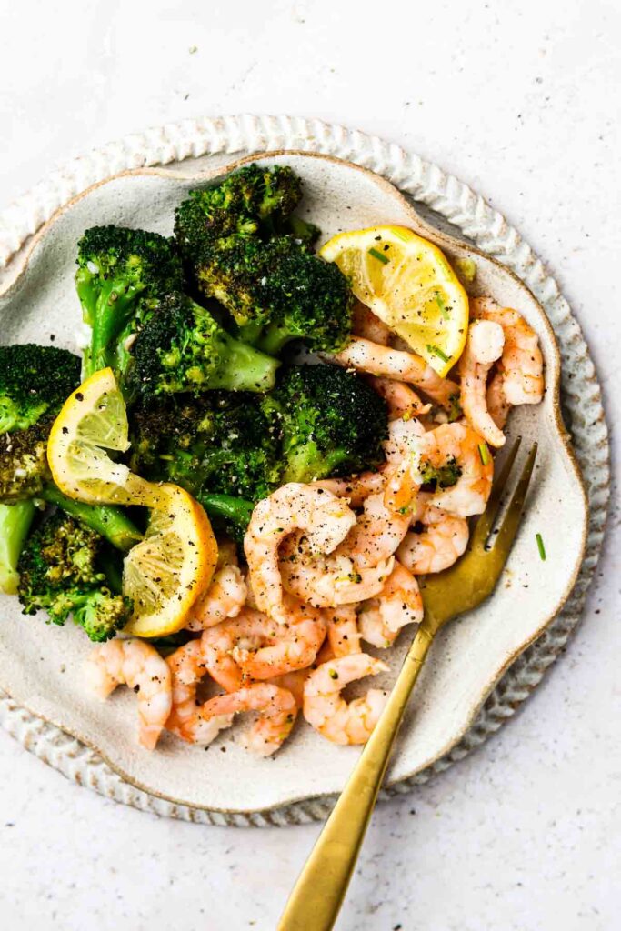 lemon garlic butter shrimp on a plate with broccoli