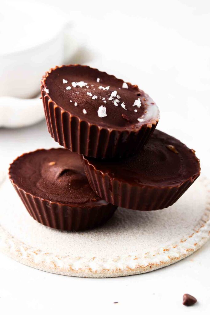 vegan peanut butter cups stacked up on a plate