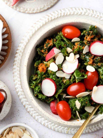 carrot ginger dressing in a bowl with tomatoes and radishes