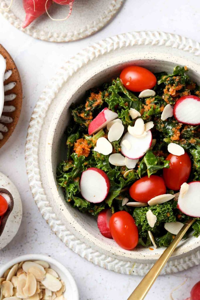 carrot ginger dressing in a bowl with tomatoes and radishes