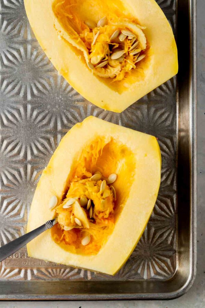 scooping out the seeds in the spaghetti squash