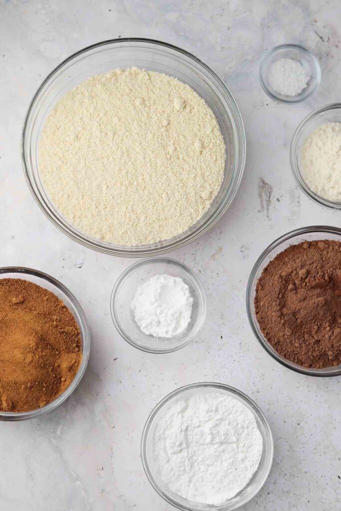 paleo chocolate cake dry ingredients laid out in bowls