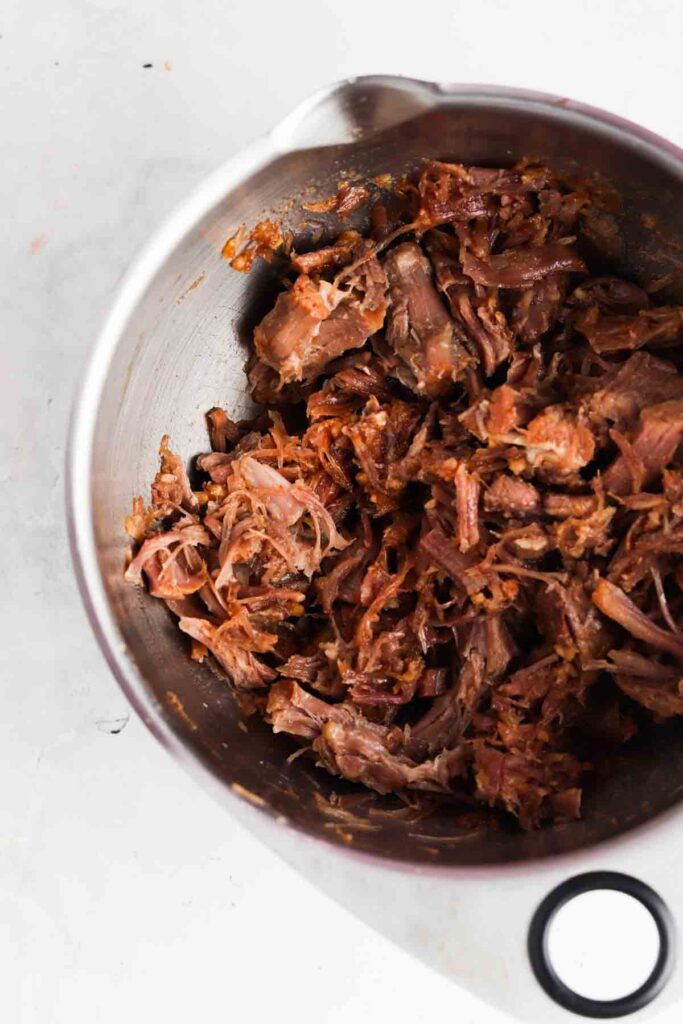 shredded pork with the sauce in a bowl