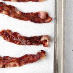 bacon cooling on a paper towel