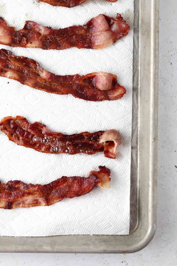 bacon cooling on a paper towel