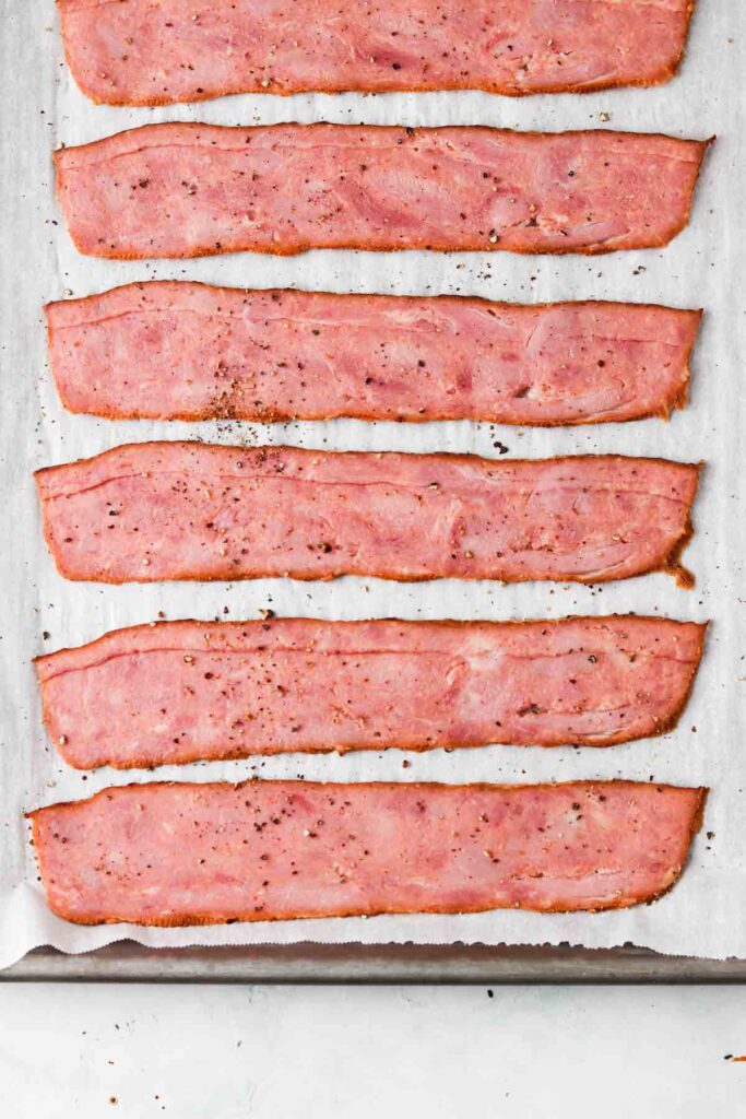 raw turkey bacon on a baking sheet