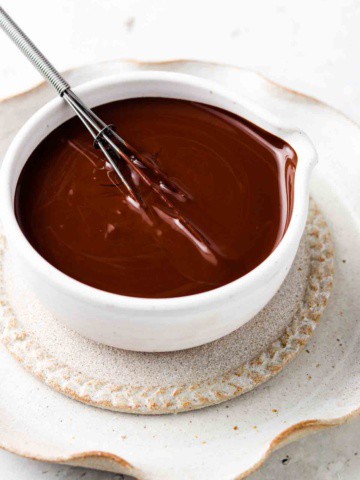 vegan chocolate ganache in a bowl with a whisk