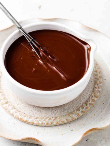 vegan chocolate ganache in a bowl with a whisk