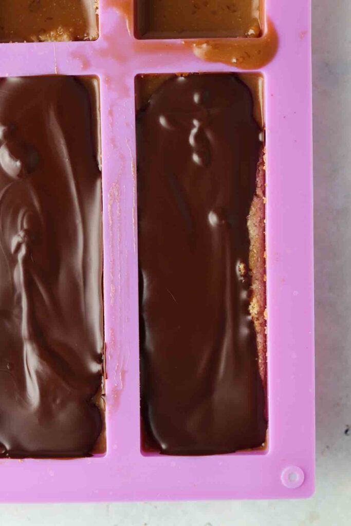 Homemade chocolate bars in a pink mold. 