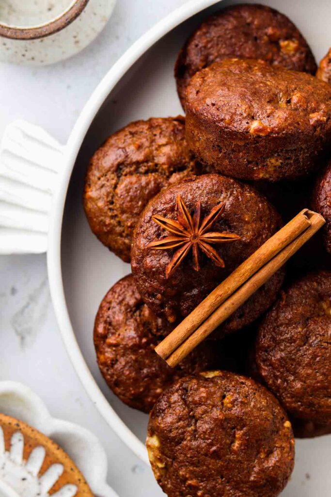 a dozen gluten free banana muffins on a plate