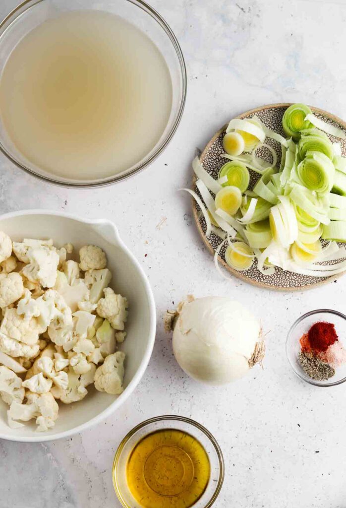 onions, leeks, bone broth, cauliflower, paprika, salt, pepper, onion powder, and avocado oil in small bowls