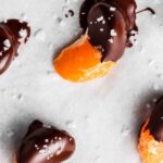 chocolate covered oranges on a baking sheet with sea salt