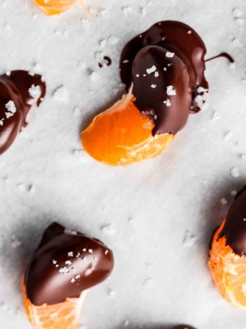 chocolate covered oranges on a baking sheet with sea salt