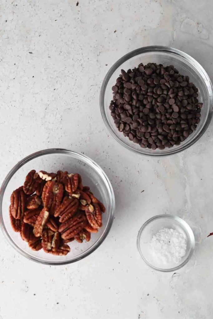 chocolate covered pecan ingredients laid out in bowls