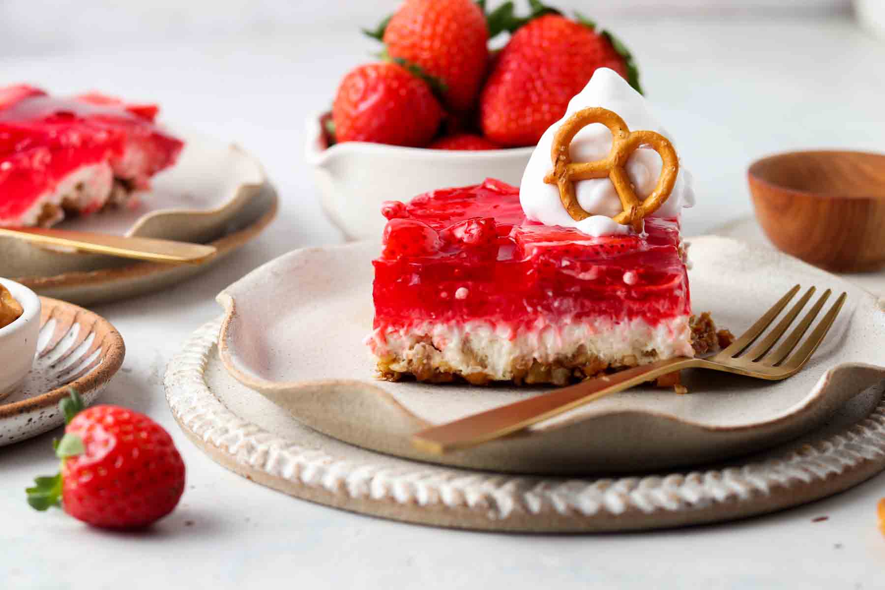 Far out shot of strawberry salad on a plate with a cold spoon.