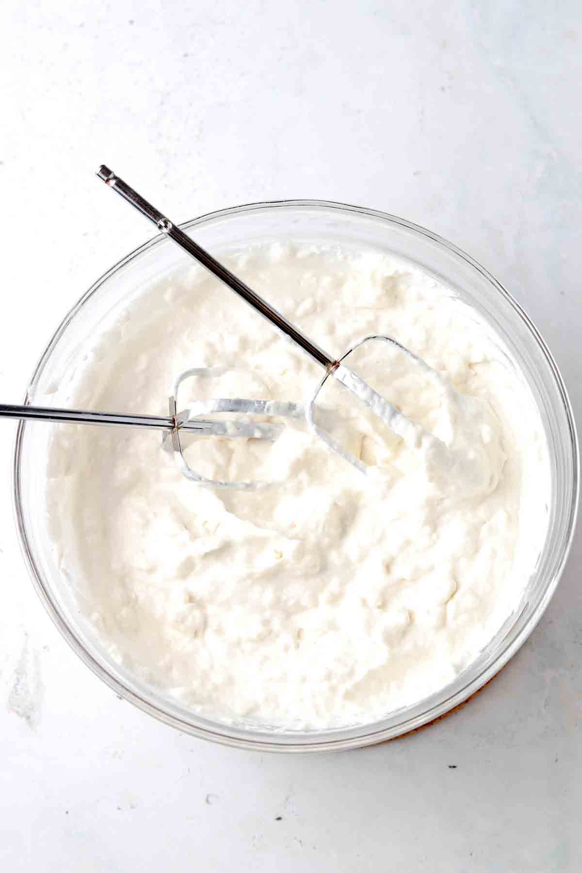 Whipped cream and cream cheese in a bowl.