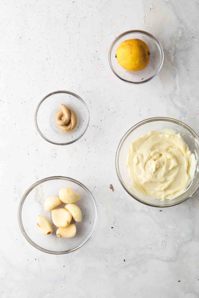 garlic aioli ingredients laid out in bowls