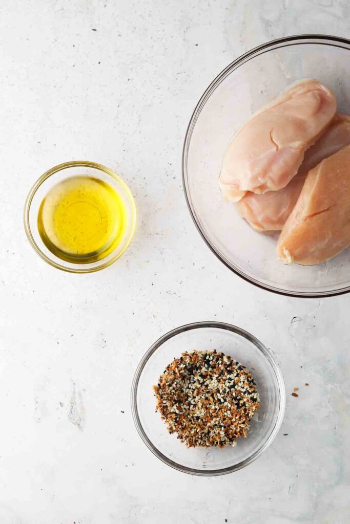 seasoned chicken ingredients laid out in bowls