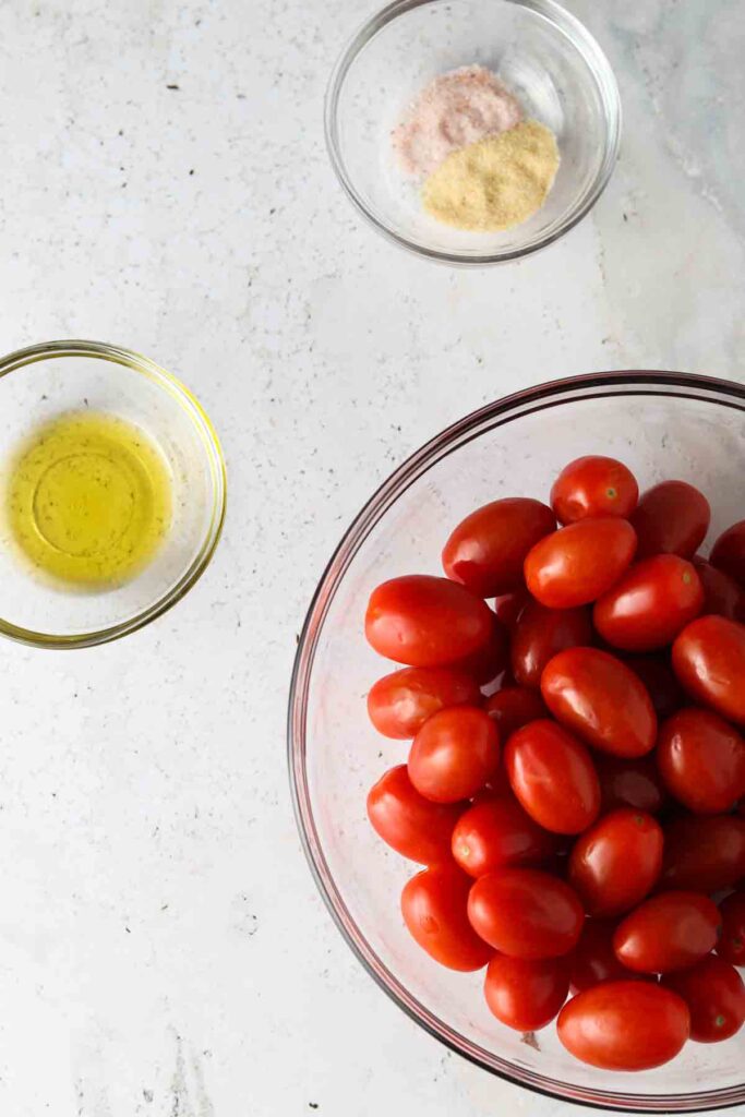 tomatoes, garlic, sea salt and oil in small bowls