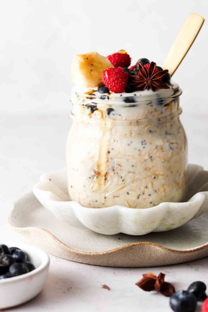 oats in a jar with fresh berries and honey drizzled on top