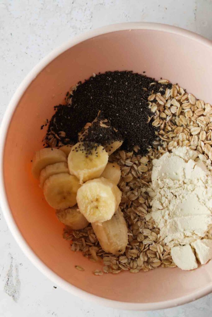 gluten free oats, banana, protein powder, chia seeds all mixed in a bowl