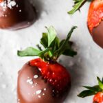 close up photo of a strawberry covered in dairy free chocolate and sea salt