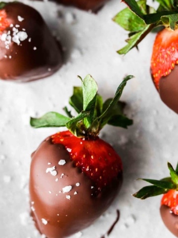 close up photo of a strawberry covered in dairy free chocolate and sea salt