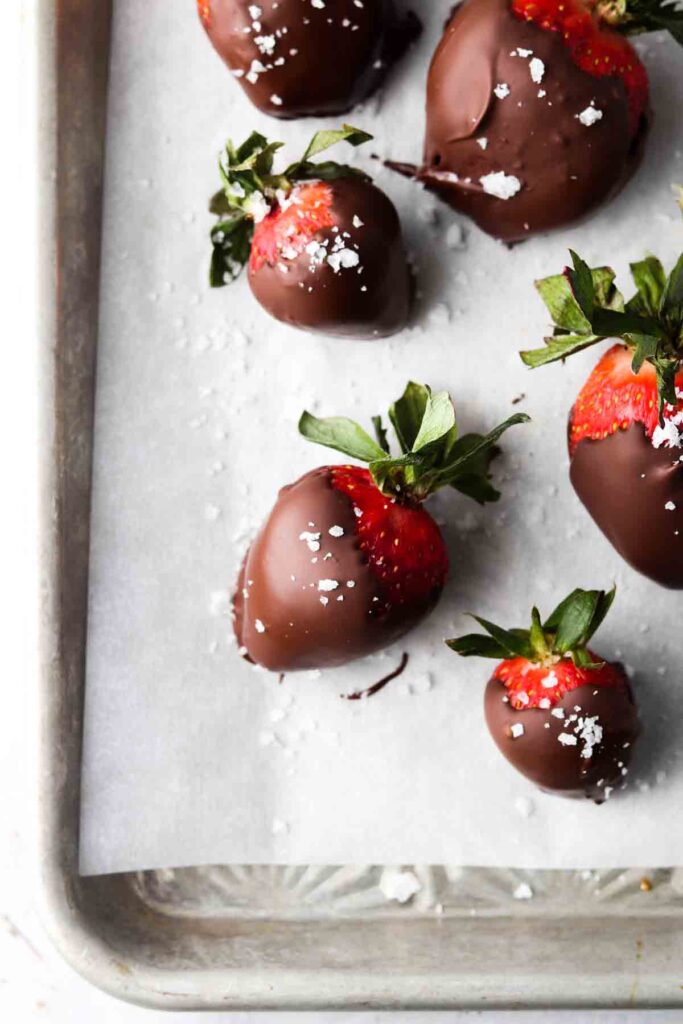 dairy free chocolate covered strawberries laid out on a sheet pan 