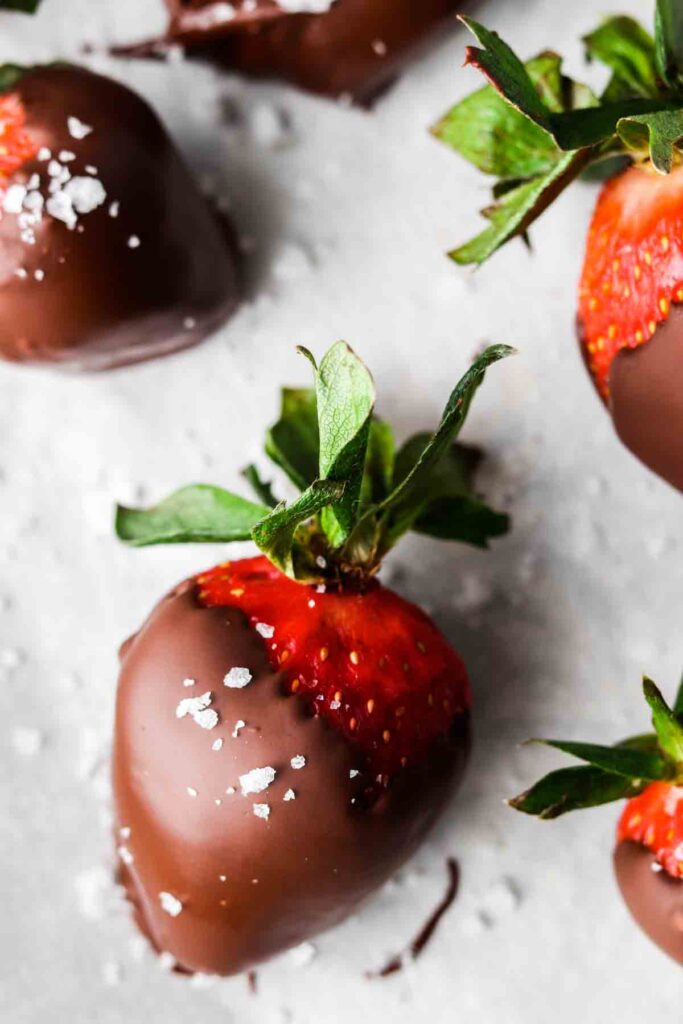 close up photo of a strawberry covered in dairy free chocolate and sea salt