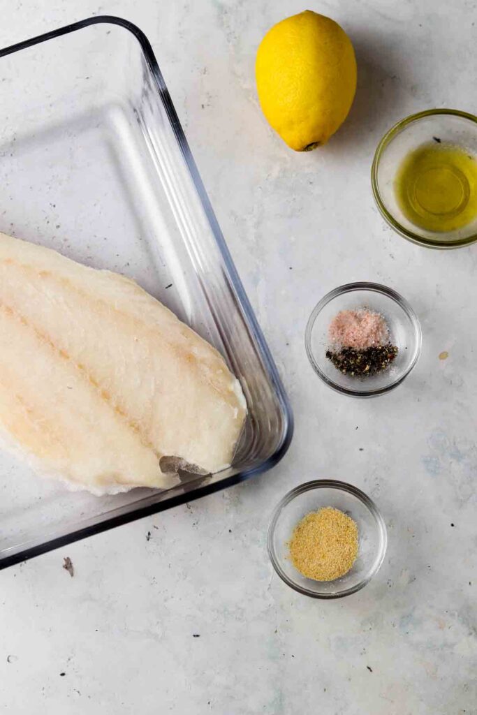 frozen cod with seasonings and oil in bowls